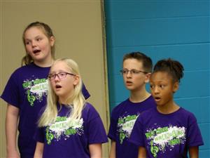 Four students in the Wrangler Choir singing